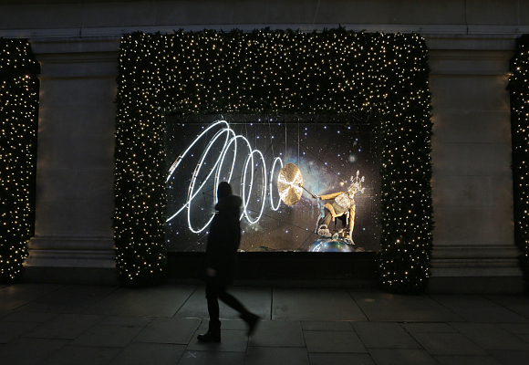 A passer by walks past the window depicting Aquarius. PHOTO MATT WRITTLE © copyright Matt Writtle 2015. Selfridges reaches for the stars with the launch of it’s new Christmas Windows. The festive theme, Journey to the Stars, which runs throughout the store, was inspired by the symbolic Christmas star and is a playful take on astrology and constellations. Combined with a celestial mix of product, the 12 windows on Oxford Street features the 12 signs of the zodiac, whilst referencing the relevant planets that influence them. The largest windows of the London store is triple-sided and showcases a giant fully rotating orrery made to scale. For further information and images, please contact: Bruno Barba Senior Brand PR Manager T +44 (0)20 7318 3204 E bruno.barba@selfridges.co.uk Jillian Macpherson Assistant Brand PR Manager T +44 (0)20 7318 3987 E jillian.macpherson@selfridges.co.uk Selfridges London.